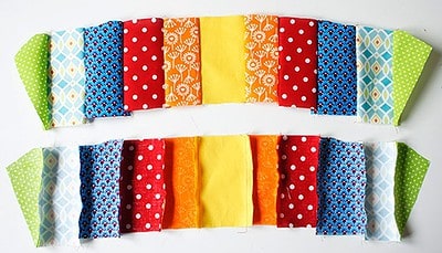 Bunte Stoffstreifen in verschiedenen Mustern und Farben, ideal für kreative Näharbeiten und Dekorationen, passend zum Thema Handarbeit und DIY.