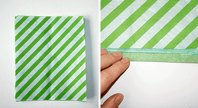 Grüner und weißer Wabenball aus Papier, hergestellt durch Falten und Zusammenkleben, ideal für DIY Dekorationen und Bastelprojekte.