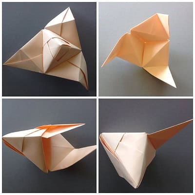 Vier Origami-Elefanten aus Papier in verschiedenen Positionen, handgefertigt, detailreich und farblich in Creme- und Orangetönen gestaltet.