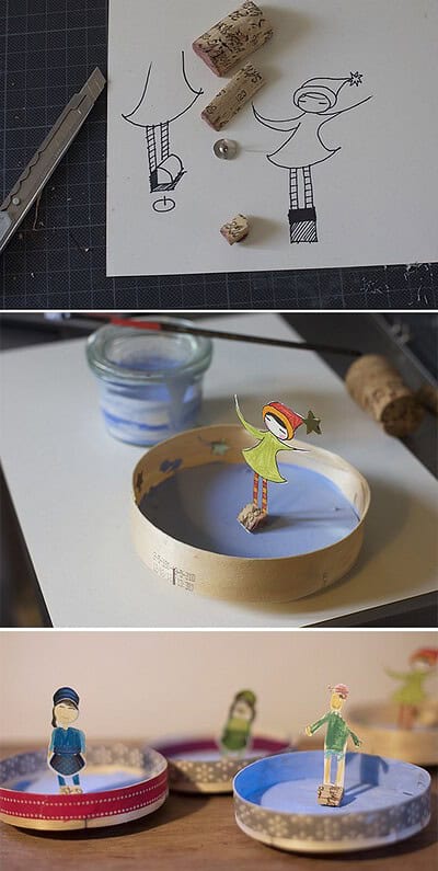 Kreative handgefertigte Eiskunstläufer Figuren aus Papier und Holz, ideal für winterliche Dekorationen und kreative Bastelprojekte.