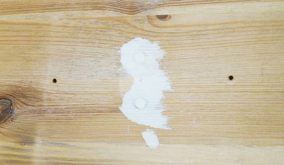 Holzoberfläche mit weißen Flecken, die durch Wasser oder Lack verursacht wurden, im Zusammenhang mit IKEA LEKSVIK Makeover.