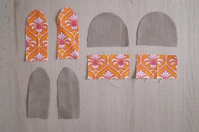 Stoffteile für niedliche Hasen zu Ostern, inklusive Ohren, Körper und Füße, in bunten Mustern und neutralen Tönen, für kreative Osterdekorationen und Geschenke.