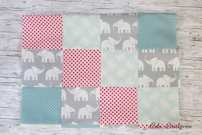 Bunte Patchwork-Decke mit Elefantenmuster in Pastellfarben, ideal für Nähmaschinenabdeckungen, handgemacht, dekorativ und funktional.
