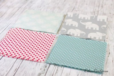 Vier bunte Patchwork-Stoffe mit verschiedenen Mustern, ideal für Nähmaschinenabdeckungen, handgemacht, kreative Nähprojekte, langlebig und stilvoll.