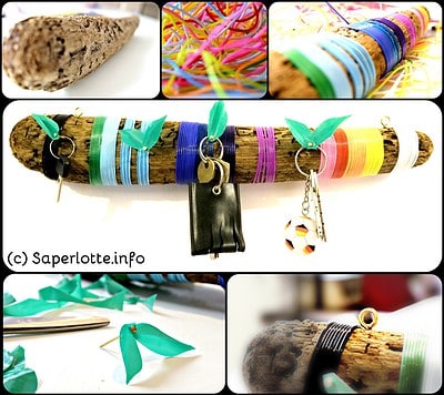 Buntes Schlüsselbrett aus Treibholz mit bunten Bändern, Schlüsselringen und Dekorationen, handgemacht, kreative Upcycling-Deko für Zuhause.