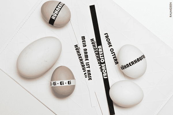 Ostereier mit Texten und Anleitungen für kreative Osterdeko, inklusive Schriftbändern und Anweisungen, ideal für Handmade-Projekte zu Ostern.
