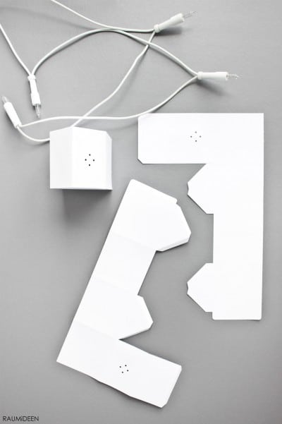 Weißes Lichterketten-Set mit verschiedenen Häuserformen, ideal für festliche Dekorationen und kreative DIY-Projekte bei HANDMADE Kultur.