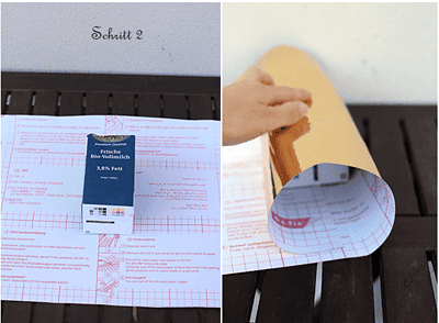 Schritt 2 der Anleitung zeigt, wie man eine Milchtüte für ein Kräuterbeet vorbereitet, inklusive Schneiden und Ausrollen des Papiers.