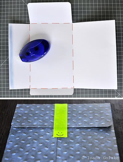 Selbstgemachte kleine Umschläge mit buntem Klebeband und Knopf, ideal für Geschenke und kleine Aufmerksamkeiten.