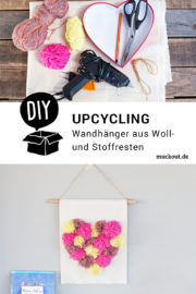 DIY-Idee: Wandhänger mit Pompom-Herz aus Wolle